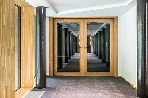 Double door made of wood and glass panels in the centre