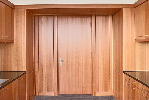 Closed wooden door in a wooden kitchen