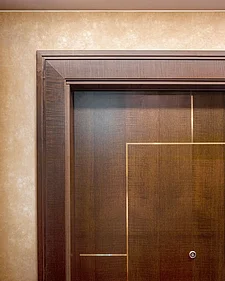 Close-up of the door frame of a dark door 